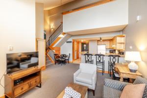 a living room with a couch and a dining room at Lizard Creek Lodge in Fernie