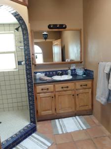 a bathroom with a sink and a mirror at Indian Ridge Casita in Willcox