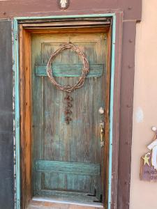 an old wooden door with a wreath on it at Indian Ridge Casita in Willcox