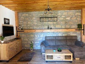 a living room with a couch and a table at Panoráma Terasz Vendégház in Noszvaj