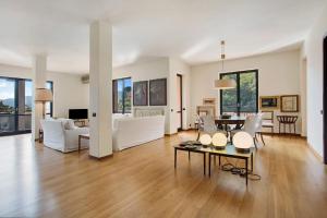 a living room with white furniture and a table at Appartamento Il Parco Cernobbio in Cernobbio