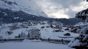 a village covered in snow with a mountain at Chalet Gletscherfloh in Grindelwald