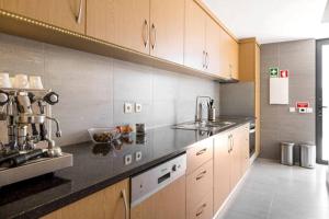 a kitchen with a sink and a counter top at Renoviertes Landhaus Für 4 Personen In Tondela in Tondela +18 photos