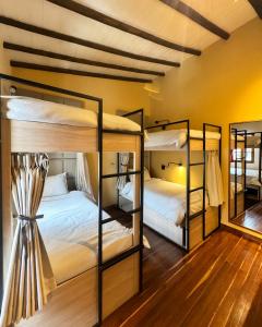 two bunk beds in a room with a mirror at Casa Dreamer Bogotá in Bogotá