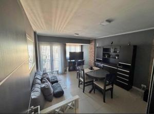 salon z kanapą i stołem w obiekcie Depto Comahue Playa Necochea w mieście Necochea