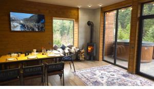 a room with a fireplace and a dining table with chairs at Спас Резорт in Spas