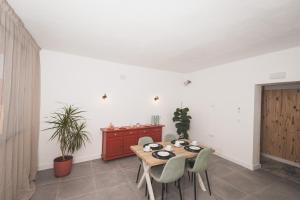 a dining room with a table and chairs and a cabinet at Hotel Rural Macondo in Trujillanos +19 photos