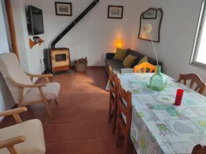 a living room with a table and a couch at Casa la Poveda in Villa del Prado