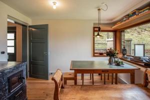 a kitchen and dining room with a table and chairs at Eggwald in Wassen