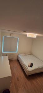 une petite chambre avec un lit et une fenêtre dans l'établissement Guesthouse good location, à Oslo