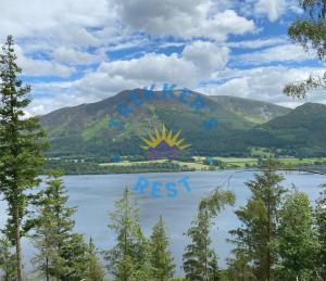 a mural on the side of a lake in front of a mountain at Trekkers Rest, Brigham, Cockermouth, Cumbria in Cockermouth