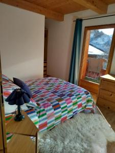 een slaapkamer met een bed en een raam bij Half duplex chalet, facing south with Mont Pourri in Sainte-Foy-Tarentaise +8 foto's