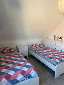 a bedroom with two beds and two dressers at Sweet Home Appartements 2 in Bottrop