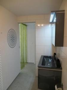 a kitchen with a sink and a counter top at Sirena in Scuol +15 photos