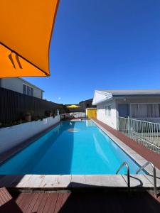 a large blue swimming pool on top of a building at Kowhai Motel Rotorua in Rotorua