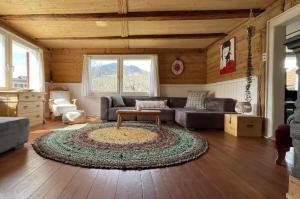 a living room with a couch and a table at Casa Marili, Das Charmante Ferienhaus in Seewis +11 photos