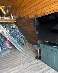 a living room with a large flat screen tv at Forest Property in Hăghiac