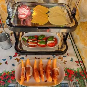 a refrigerator with cheese and meats and a plate of food at Il Melograno Vrbanj Hvar in Vrbanj