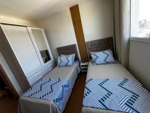 Giường trong phòng chung tại Refúgio tranquilo no coração de São Pedro