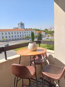 a table and chairs on a balcony with a view at Stay&view Santarém in Santarém