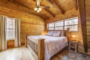 a bedroom with a bed in a log cabin at Elevated Cabin Bordering Smoky Mountain Nat'l Park in Bryson City