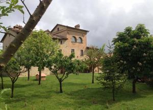a large building with trees in front of it at Monastery Biribino in Città di Castello