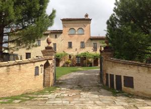 a large brick building with a tower on top at Monastery Biribino in Città di Castello