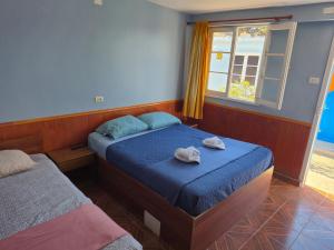 Postel nebo postele na pokoji v ubytování Illariy Wasi Hostal