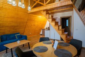 a living room with a table and a blue couch at Art A Cabin in Teşila
