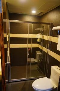 a bathroom with a glass shower with a toilet at LeaLea Garden Hotels - Moon Lake in Yuchi