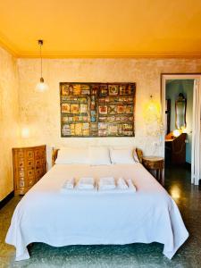 a bedroom with a large white bed with towels on it at Carmen Guillemot in Alcanar +115 photos