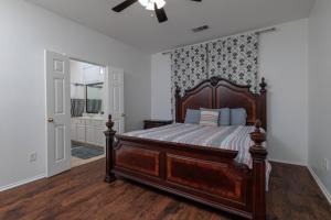 a bedroom with a large wooden bed in a room at Fenced Backyard - Workspace - Near DFW Airport in Euless