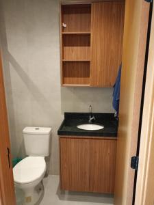 a small bathroom with a toilet and a sink at Flat has rooftop with barbecue and sea view in Tamandaré