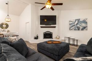 a living room with a couch and a fire place at Private Pool - Game Room - Backyard TV - Fenced Yard in Plano