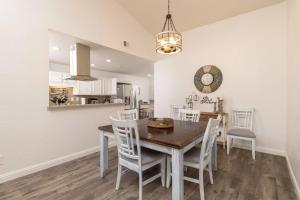 a dining room and kitchen with a table and chairs at Private Pool - Game Room - Backyard TV - Fenced Yard in Plano