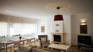 a living room with a table and a fireplace at Sister's House by east ALgarve guest in Tavira +16 photos