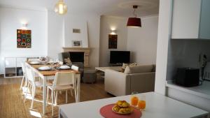 a kitchen and living room with a table and a couch at Sister's House by east ALgarve guest in Tavira