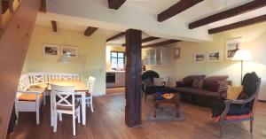 a living room with a couch and a table at Ferienhaus Im Idyllischsten Winkel Rügens in Neuenkirchen