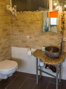 a bathroom with a sink and a toilet at Wohnung In Niedergurig Mit Grill, Sauna Und Garten in Malschwitz +28 photos