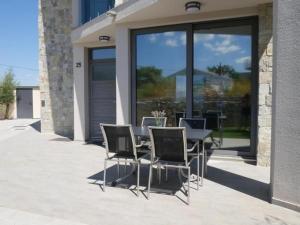 a patio with a table and chairs in front of a building at Villa Paradise in Vrbnik