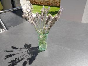 a vase filled with flowers sitting on a table at Villa Paradise in Vrbnik