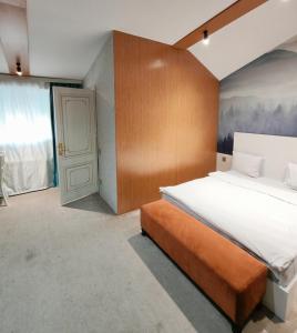 a bedroom with a large bed and a door at Twins MIRROR group HOTELS in Baku +33 photos
