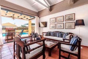 a living room with a couch and chairs and a patio at Barbati Beach - Villa Zante in Barbati +19 photos
