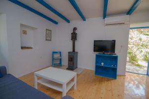 a living room with a tv and a table at Haus Boris in Veli Lošinj