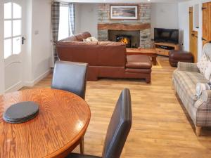 a living room with a couch and a table at Rhoshill in Llanfyrnach