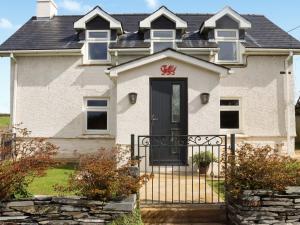 a large white house with a black door at Rhoshill in Llanfyrnach