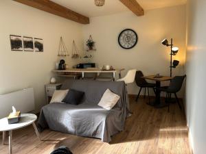 a bedroom with a bed and a desk and a table at La maison du bonheur 17 in Marans