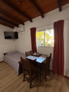 a room with a table and a bed and a window at Babella 2 in Concordia +20 photos