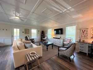 a living room with a couch and a table at Serenity Now in Edisto Island