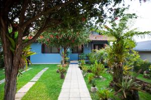 een tuin voor een blauw huis bij Casa Joseph in Gramado